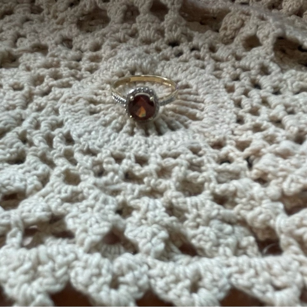 14K gold ring with a red center stone.
